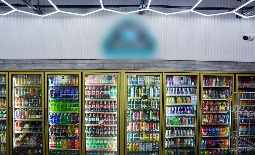 A long wall of lit drink coolers